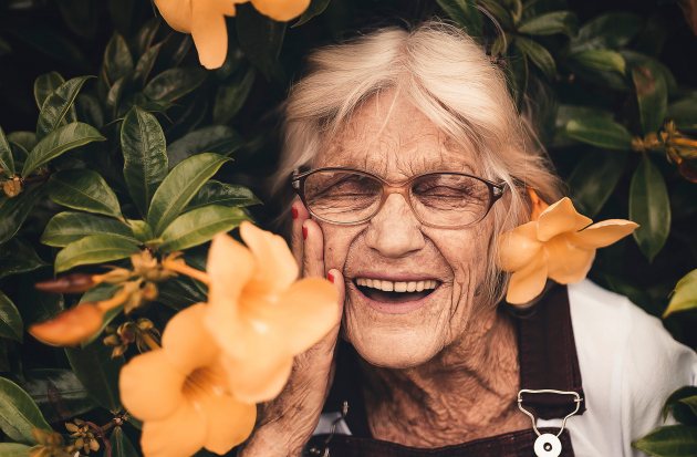 Oudere dame tussen de bloemen